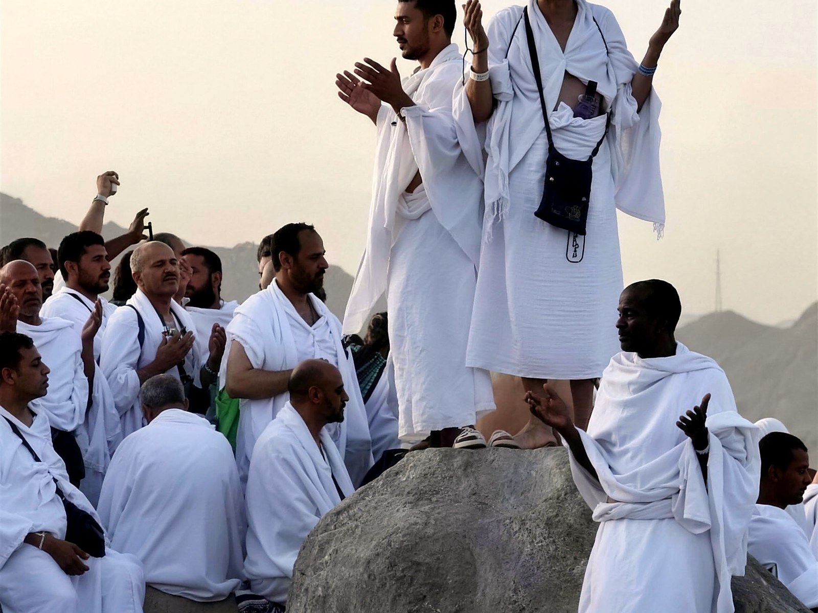 Pilgrims in ihram raising their hands in dua on the Day of Arafah, Makkah