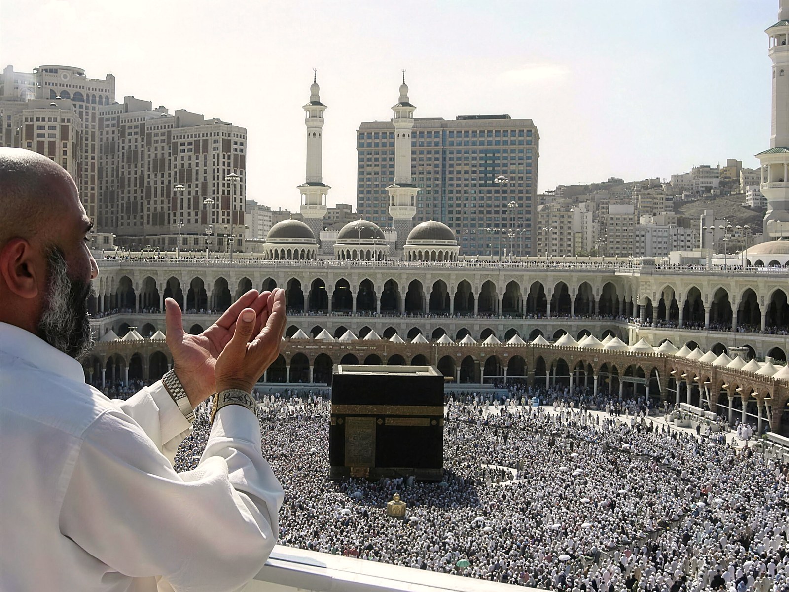 A pilgrim raising his hands in dua before the Holy Kaaba, Masjid al-Haram, Makkah
