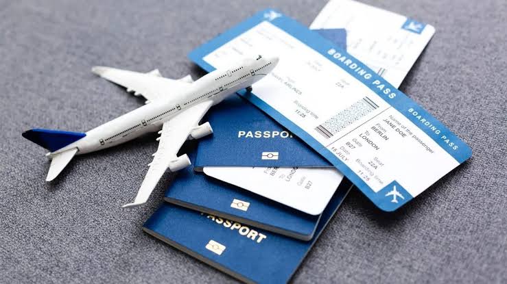A model aircraft resting on passports and boarding passes